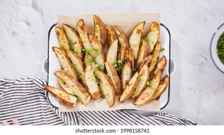 Flat lay. Step by step. Preparing russet potatoes in wedges with olive oil and spices to bake in the oven. - Shutterstock ID 1998158741