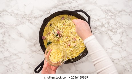 Flat lay. Step by step. Preparing spinach and ham frittata in cast iron skillet.