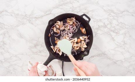 Flat lay. Step by step. Sauteeing purple onion and mushrooms for spinach and ham frittata.