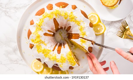 Flat lay. Step by step. Slicing lemon bundt cake decorated with lemon zest on a cake stand.