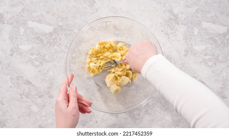Flat lay. Step by step. Smashing riped bananas in a glass mixing bowl to prepare coconut banana pancakes. - Shutterstock ID 2217452359