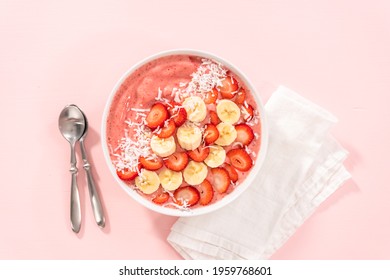 Flat Lay. Strawberry And Banana Smoothie Bowl Garnished With Coconut Flakes And Fresh Fruits.