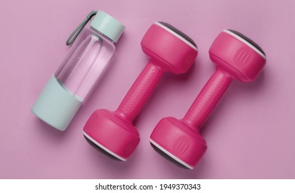 Flat lay style concept of healthy lifestyle, sport and fitness. Dumbbells, bottle of water on pink pastel background. Top view - Shutterstock ID 1949370343