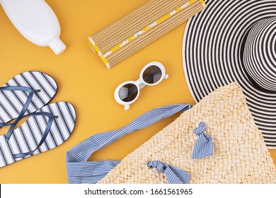 Flat Lay With Summer Accessories For Woman. Sun Hat, Sunglasses, Sunscreen Protection, Flip Flops And Bag. Summer Travel, Vacatoins, Heat Protection Concept. Copy Space, Top View