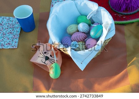 Flat lay of tablecloth and easter decoration as painted eggs and bunny bag