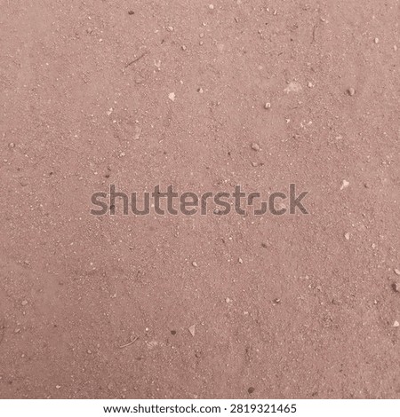 Flat lay texture of rough reddish brown dirt sand and fine gravel surface creating a natural earthy background wallpaper