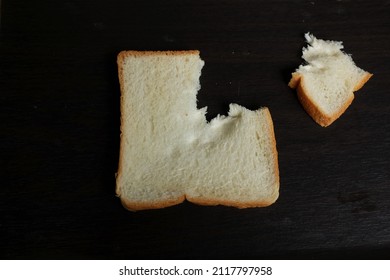 flat lay and top view bread crumbs  or leftover bread on a black background