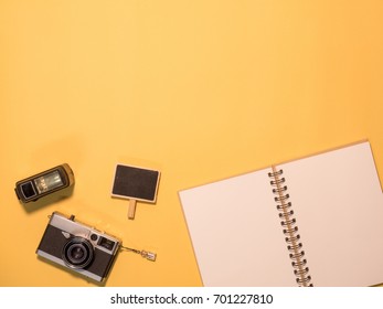 Flat Lay, Top View of Camera and photography tool on yellow background with space
