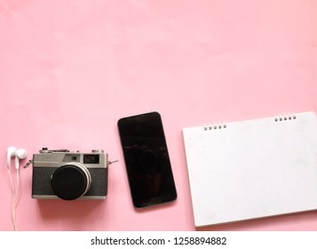 flat lay and top view ,copy space travel accessories  notebook ,mobile phone ,glasses, camera  