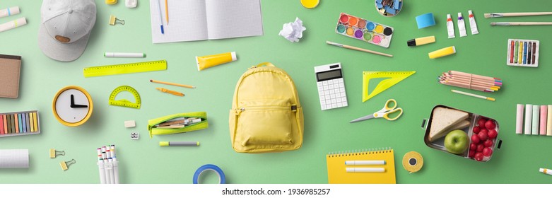 Flat lay top view of face mask and school supplies, back to school and coronavirus concept. - Shutterstock ID 1936985257