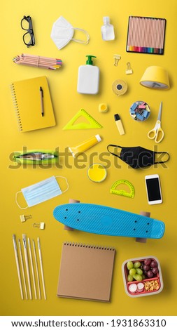 Flat lay top view of face mask and school supplies, back to school and coronavirus concept.