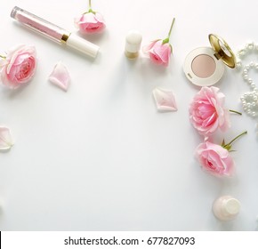 Flat Lay, Top View  Feminine Desk, Workspace , Female Make Up Accessories, Cosmetics And Pink Roses.Beauty  Concept.Copy Space