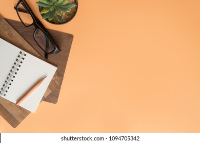 Flat Lay, Top View Office Table Desk. Workspace With Blank Note Book, Keyboard, Office Supplies  And Coffee Cup On Color Background.