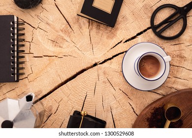 Flat lay, top view office table desk. Workspace with office supplies, pencil, green leaf, and coffee cup on wooden textured background.