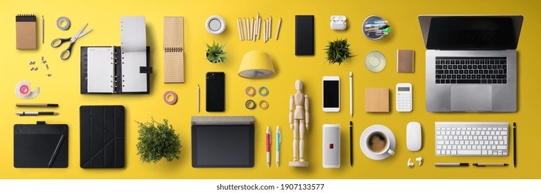 Flat lay top view office desk working space with laptop and supplies on yellow background. - Powered by Shutterstock