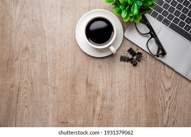 Flat Lay, Top View Office Table Desk. Workspace With, Laptop,office Supplies, Pencil, Green Leaf, And Coffee Cup On Wood Background.