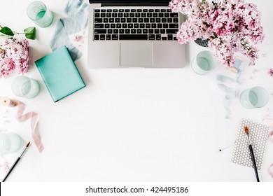 Flat lay, top view office table desk. Workspace with paintbrush, laptop, lilac flowers bouquet, spool with beige and blue ribbon, mint diary on white background. - Powered by Shutterstock