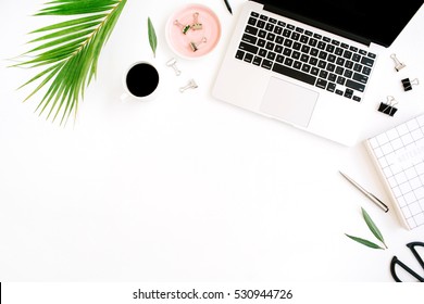 Flat Lay, Top View Office Table Desk. Workspace With Notebook, Laptop, Palm Branch, Coffee Cup, Scissors And Clips On White Background.