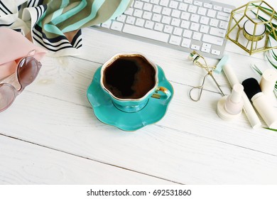 Flat lay, top view office feminine desk, female make up accessories, workspace with laptop, cup of coffee .Beauty blog concept