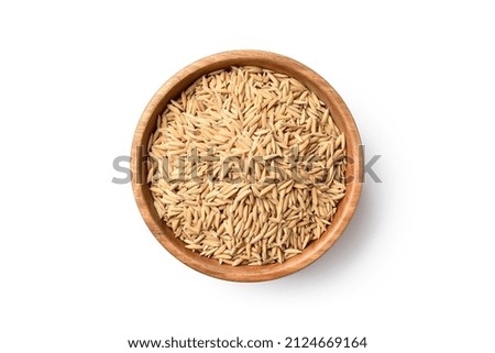 Flat lay (top view) of paddy jasmine rice in wooden bowl isolated on white background. Clipping path.