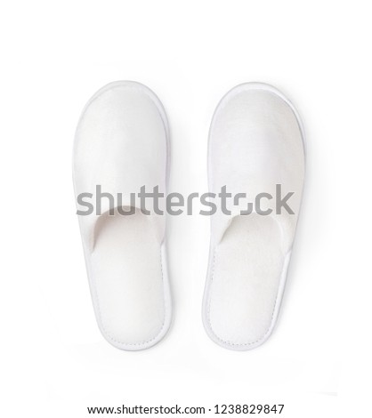 Flat lay (top view) of Soft white home or spa slippers isolated on white background with clipping path.