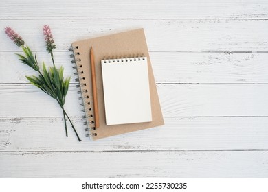 Flat lay, Top view text and leave a message concept on vintage white wooden table desk background with stack blank notepad and green plant,  stationeries, copy space - Powered by Shutterstock