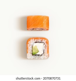 Flat lay of two Philadelphia rolls isolated on white. Top view of sushi with salmon and cream cheese