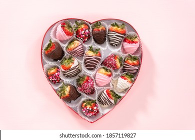 Flat lay. Variety of chocolate dipped strawberries in a heart-shaped box.