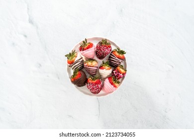 Flat lay. Variety of chocolate dipped strawberries on a cake stand.