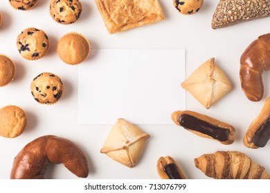 flat lay with various types of pastry and blank card isolated on white