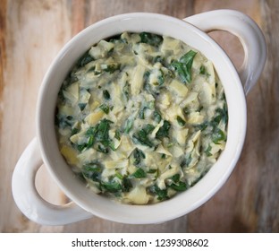 Flat lay of vegan spinach artichoke dip in bowl