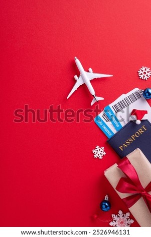 Flat lay vertical image of a toy airplane, passport, boarding pass, and gift on a festive red background symbolizing holiday travel planning