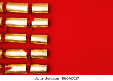 Flat Lay With Victorian Christmas Cracker On Red Background.