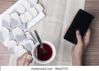 Flat lay view of a man's hand having morning tea or hi-tea.
