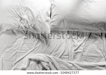 Similar – Image, Stock Photo Unmade bed with pillows and crumpled bedsheets and open laptop