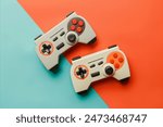 flat lay view of vintage 1980s computer game controllers on a bright color background