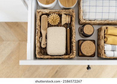 Flat Lay View Of Zero Waste Products Inside Organization Boxes And Wicker Baskets. Open Drawer At Kitchen Closet With Washing Dishes Items, Bamboo Brushes, Eco Friendly Sponge And Textile Towel