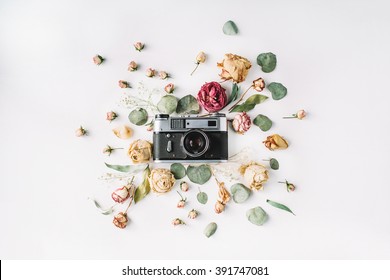 Flat lay. Vintage retro photo camera, beige roses and green leaves, top view - Powered by Shutterstock