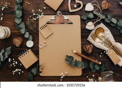 Flat Lay Wedding Planning. Craft Clipboard With Rustic Decorations On Wooden Background. Vintage Greenery Wedding Details 