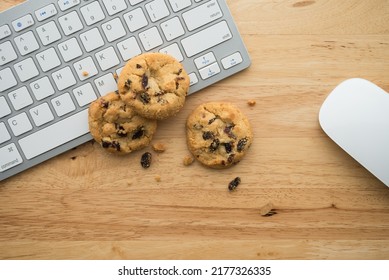 Flat Lay Of White Chocolate Chip Cookies On Keyboard Computer And Mouse On Wooden Table Background Copy Space. Cookies Website Internet Homepage Policy Accepted Or Blocks Concept.