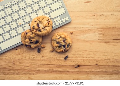 Flat Lay Of White Chocolate Chip Cookies On Keyboard Computer On Wooden Table Background Copy Space. Cookies Website Internet Homepage Policy Accepted Or Blocks Concept.