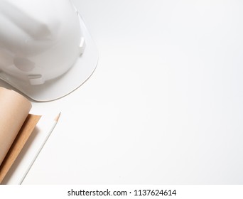 Flat Lay White Hard Safety Helmet With Paper And Pencil For Engineering Worker Isolated On White Background Top View With Space.