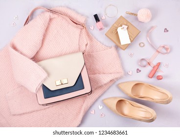 Flat lay of woman clothing and accessories in pastel colors. Modern classic style concept - Shutterstock ID 1234683661