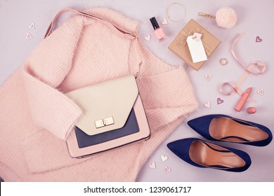 Flat lay of woman clothing and accessories in pastel colors. Modern classic style concept - Shutterstock ID 1239061717