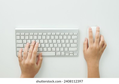 Flat lay woman hands on white desk use pc computer silver keyboard and mouse. Top view. Female hands typing on keyboard at white table workplace. Home office workspace with keyboard mouse glasses. - Powered by Shutterstock