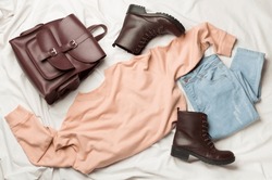 Flat Lay with women casual outfit on white bed sheet, top view., a Beauty & Fashion Photo by Liami