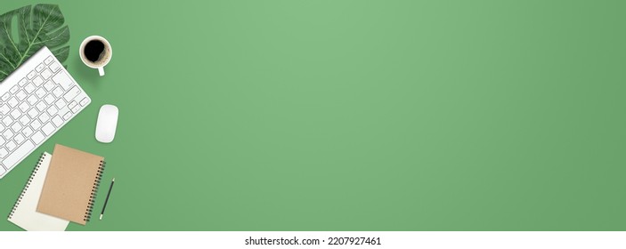 Flat lay work desk table with computer , book , coffee on green pastel color tone background include empty space for product or text graphic advertise - Shutterstock ID 2207927461