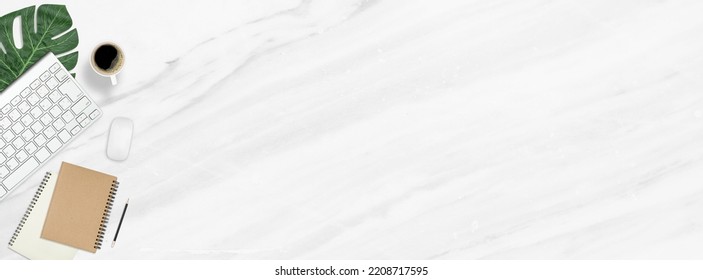 Flat lay work desk table with computer , book , coffee on marble texture background include empty space for product or text graphic advertise