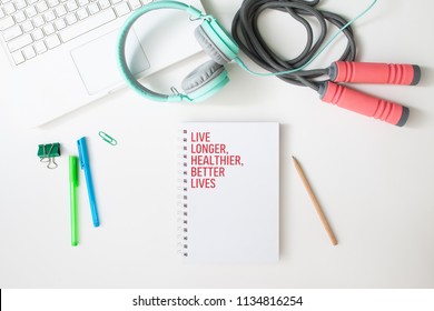 Flat lay of workspace laptop computer, headphones, fitness equipment and notebook, Healthy lifestyle concept