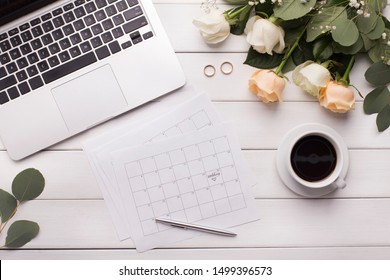 Flat Lay Workspace. Wedding Date In Paper Calendar And Laptop For Planning Time And Budget On Wooden Office Table